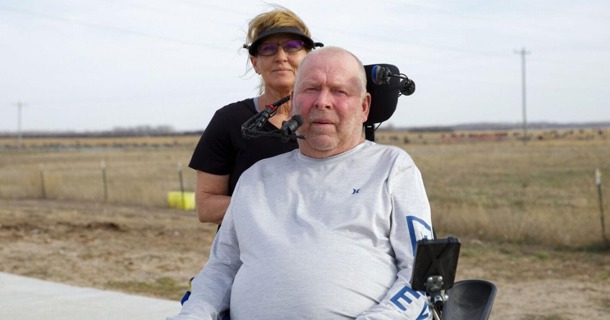 Kevin and Jacque Daniels live outside of Norfolk where they own a feedlot and work with horses. Kevin has a condition called Guillain-Barré that has left him paralyzed from the neck down. He is slowly gaining back movement and said he hopes to one day restore his mobility. He gets around his farm using his electric wheelchair, provided by AgrAbility, and operates it by pressing his cheek and chin against the features of the chair reaching from behind the headrest. The couple learned about AgrAbility through a friend who knew about the program.